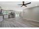 Bright kitchen boasts white cabinets, stainless steel appliances, and modern gray flooring at 4176 King Edward Dr, Douglasville, GA 30135