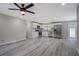 Open concept kitchen with stainless appliances, white cabinetry and gray wood-look floors at 4176 King Edward Dr, Douglasville, GA 30135