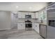 Renovated kitchen featuring stainless steel appliances, granite countertops, and white cabinets at 4176 King Edward Dr, Douglasville, GA 30135