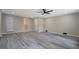 Open living area featuring stylish gray flooring, neutral walls, updated lighting, and multiple doorways at 4176 King Edward Dr, Douglasville, GA 30135