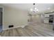 Open concept living room shows wood-look flooring and modern chandelier at 4176 King Edward Dr, Douglasville, GA 30135