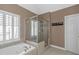 Bathroom showcasing tub, separate shower, and bright window at 5810 Old Mill Trce, Lithonia, GA 30038