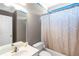 Neutral bathroom with vanity, toilet, and shower with patterned curtain at 5810 Old Mill Trce, Lithonia, GA 30038