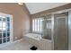 Bathroom with a shower, soaking tub and mosaic-detailed door at 5810 Old Mill Trce, Lithonia, GA 30038