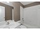 Bathroom featuring a white sink, white shower-tub combination, and white toilet at 5810 Old Mill Trce, Lithonia, GA 30038