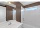 Bathroom featuring a white sink, white shower-tub combination, and bright lighting at 5810 Old Mill Trce, Lithonia, GA 30038