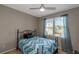 Cozy bedroom with natural light, ceiling fan, and window with blue curtains at 5810 Old Mill Trce, Lithonia, GA 30038