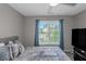Inviting bedroom with a comfortable bed, ceiling fan, and view from the window at 5810 Old Mill Trce, Lithonia, GA 30038