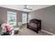 Cozy bedroom with a dark wood crib, rocking chair, and large windows at 5810 Old Mill Trce, Lithonia, GA 30038