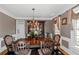 Formal dining room boasting an elegant chandelier, hardwood floors, and sophisticated décor at 5810 Old Mill Trce, Lithonia, GA 30038