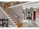 Grand foyer with elegant staircase, decorative iron railings, and a marble floor creating an inviting entrance at 5810 Old Mill Trce, Lithonia, GA 30038