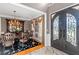Elegant foyer showcasing a decorative front door, hardwood floors, and a formal dining area at 5810 Old Mill Trce, Lithonia, GA 30038