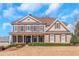 Stately two-story home with a welcoming front porch, manicured lawn, and classic architectural details at 5810 Old Mill Trce, Lithonia, GA 30038