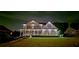 Striking home illuminated at night, showcasing a beautifully landscaped yard and inviting facade at 5810 Old Mill Trce, Lithonia, GA 30038