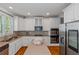 Bright kitchen featuring white cabinetry, stainless steel appliances, an island, and hardwood floors at 5810 Old Mill Trce, Lithonia, GA 30038