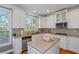 Bright kitchen with stainless steel appliances, stone countertops, and white cabinets at 5810 Old Mill Trce, Lithonia, GA 30038