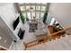 Elevated view of the living room with large windows, fireplace, comfortable seating, and access to dining area at 5810 Old Mill Trce, Lithonia, GA 30038