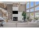 Bright living room features soaring windows, fireplace with large television, and comfortable seating at 5810 Old Mill Trce, Lithonia, GA 30038
