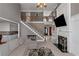 Spacious living room with fireplace, large windows, and a staircase leading to the second floor at 5810 Old Mill Trce, Lithonia, GA 30038