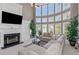 A grand living room features tall windows, a fireplace, a large screen television, and elegant furniture at 5810 Old Mill Trce, Lithonia, GA 30038
