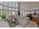 Bright living space with high ceilings, large windows, and an open layout connecting to the kitchen at 5810 Old Mill Trce, Lithonia, GA 30038