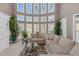 Sun-drenched living room with soaring windows, neutral palette, and comfortable seating arrangement at 5810 Old Mill Trce, Lithonia, GA 30038