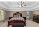 Cozy main bedroom showcasing tray ceilings, natural light, and bedside tables at 5810 Old Mill Trce, Lithonia, GA 30038