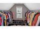 Walk-in closet featuring ample storage with many clothes, shoes, and natural light at 5810 Old Mill Trce, Lithonia, GA 30038