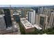 Aerial view of building showcasing the surrounding city, lush green trees, and swimming pool at 845 Spring Nw St # Ph 5, Atlanta, GA 30308