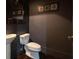 A charming powder room featuring pedestal sink, dark gray walls, and decorative mirror, and wall decor at 845 Spring Nw St # Ph 5, Atlanta, GA 30308