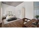 Staged bedroom featuring a comfortable bed, desk, and hardwood floors at 845 Spring Nw St # Ph 5, Atlanta, GA 30308