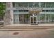 Building entrance of Midcity Lofts, featuring large glass windows, stone accents, and prominent signage at 845 Spring Nw St # Ph 5, Atlanta, GA 30308