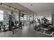 Fully equipped fitness center featuring modern exercise equipment and floor to ceiling windows overlooking city views at 845 Spring Nw St # Ph 5, Atlanta, GA 30308