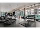 Fitness center filled with treadmills, weight machines, free weights, and large windows with cityscape views at 845 Spring Nw St # Ph 5, Atlanta, GA 30308
