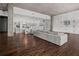 Open-concept living area with concrete ceilings, hardwood floors, and light-colored modern furniture at 845 Spring Nw St # Ph 5, Atlanta, GA 30308