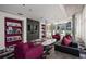Comfortable living room featuring built-in bookshelves, modern furnishings, and large windows with cityscape views at 845 Spring Nw St # Ph 5, Atlanta, GA 30308
