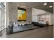 Lobby area featuring stone wall, sofa, modern chandelier, and a reception desk with marble countertops at 845 Spring Nw St # Ph 5, Atlanta, GA 30308