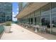 Patio seating area includes dining tables and seating, with the backdrop of city views through large windows at 845 Spring Nw St # Ph 5, Atlanta, GA 30308