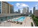 Rooftop pool featuring city views, lounge chairs, and a modern deck on the top of the building at 845 Spring Nw St # Ph 5, Atlanta, GA 30308