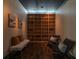 Comfortable sitting area with built-in shelving, two chairs, a bench, and art on the walls at 845 Spring Nw St # Ph 5, Atlanta, GA 30308