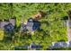 Aerial view showcasing the layout of the 1900 sqft property, surrounded by lush trees and a well-manicured lawn at 4890 Old Briar Trl, Douglasville, GA 30135