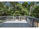 Spacious back deck features wood railings and overlooks mature trees and yard at 4890 Old Briar Trl, Douglasville, GA 30135