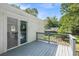 A bright back deck with wood railings and a slider into the dining room at 4890 Old Briar Trl, Douglasville, GA 30135