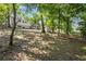 Large backyard space with mature trees providing privacy and shade at 4890 Old Briar Trl, Douglasville, GA 30135