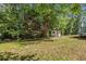 Lush backyard with an outbuilding and mature trees; plenty of space for outdoor activities at 4890 Old Briar Trl, Douglasville, GA 30135