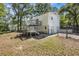 Exterior backyard view with a deck and second story deck; features a fenced yard and lush trees around property at 4890 Old Briar Trl, Douglasville, GA 30135