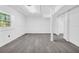 Open basement features paneled walls and ceiling and laminate floors with natural light at 4890 Old Briar Trl, Douglasville, GA 30135