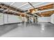 Spacious unfinished basement with painted floor and exposed utilities, ready for customization at 4890 Old Briar Trl, Douglasville, GA 30135
