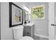 Charming bathroom features a modern vanity, stylish mirror, and plenty of natural light at 4890 Old Briar Trl, Douglasville, GA 30135
