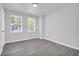 Bedroom showcases neutral walls and flooring with bright light from large windows at 4890 Old Briar Trl, Douglasville, GA 30135